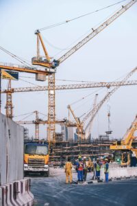 very high cranes working and workers talking, at a construction