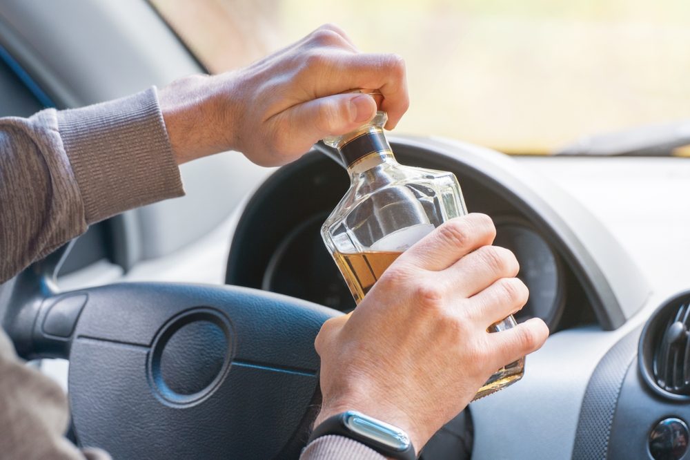A man opening a bottle of liquor while driving. What is the average DUI accident settlement?