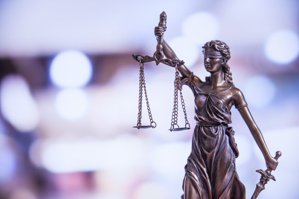 A statute of the scales of justice. Can you sue UPS if a delivery driver hits your car?